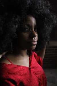 a woman with an afro in a red dress