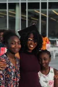 a group of women posing for a photo in front of a building